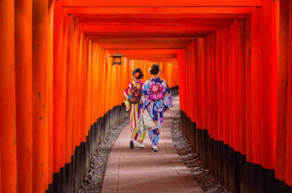 Women in traditional japanese kimonos walking at Fushimi Inari Shrine in Kyoto, Japan